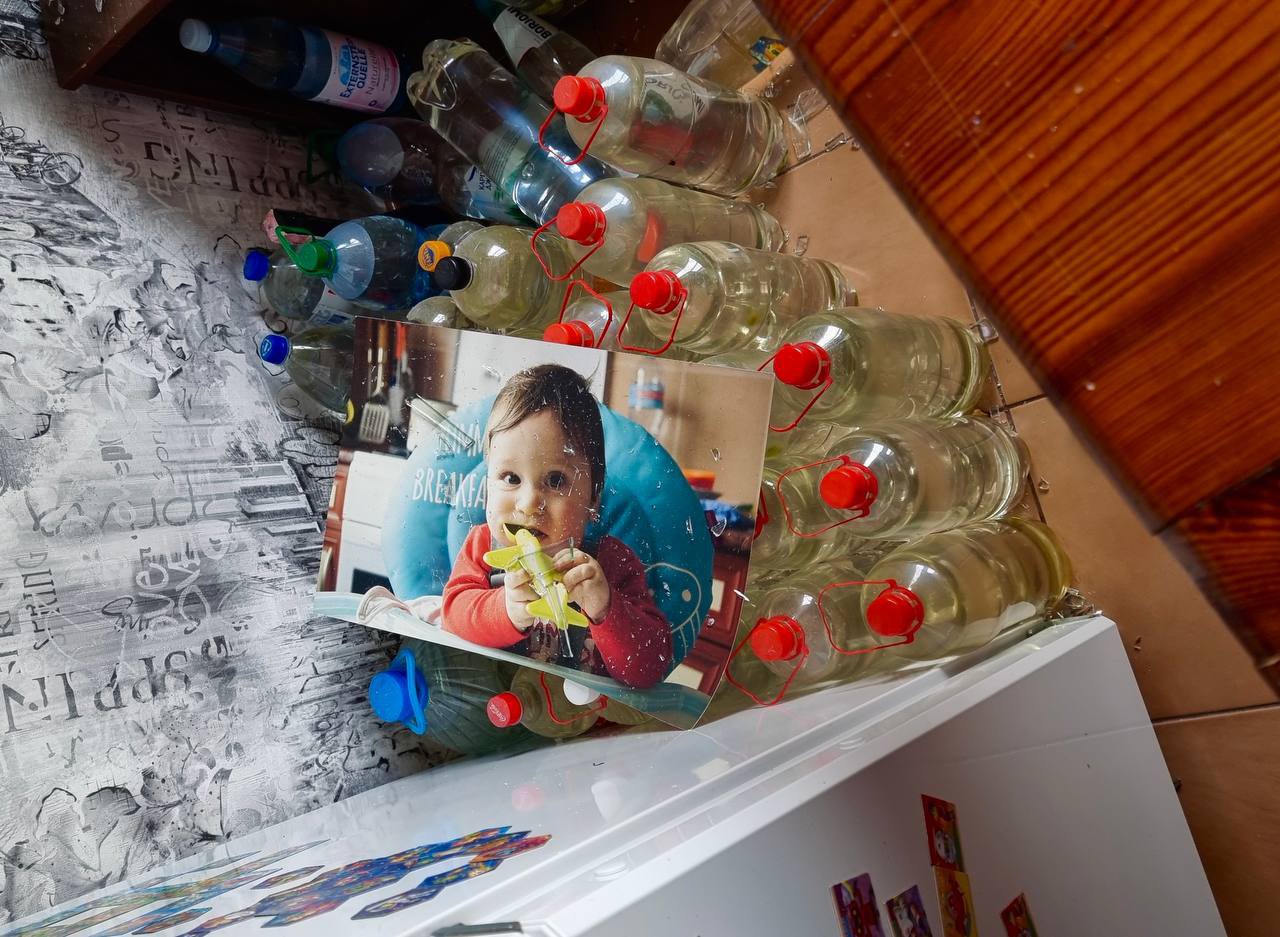 A photo of the younger son of Damir Demidovets with scratches from shattered glass, which hung in the kitchen for many years.