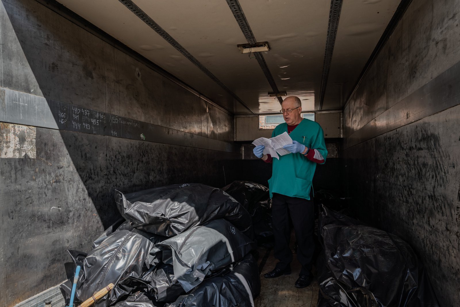 Ihor Viktorovych, a forensic medical expert from Bila Tserkva, is checking against the victim list.