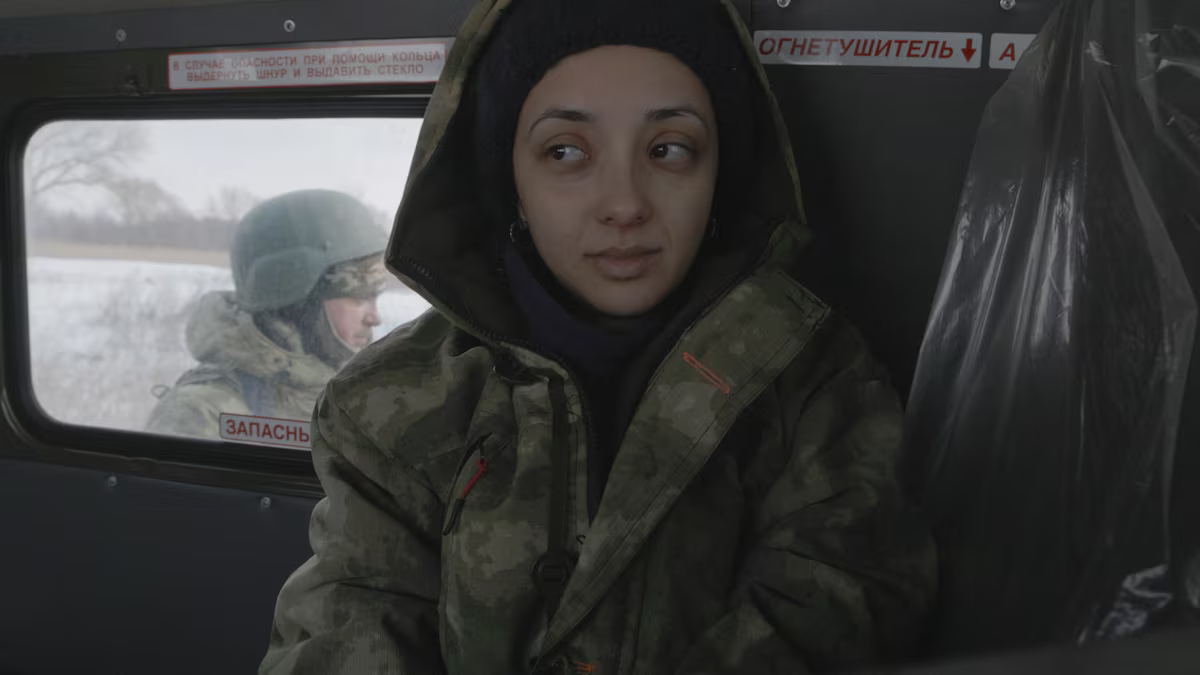 Anastasia Trofimova wearing Russian uniform among Russian military. Scene from the movie