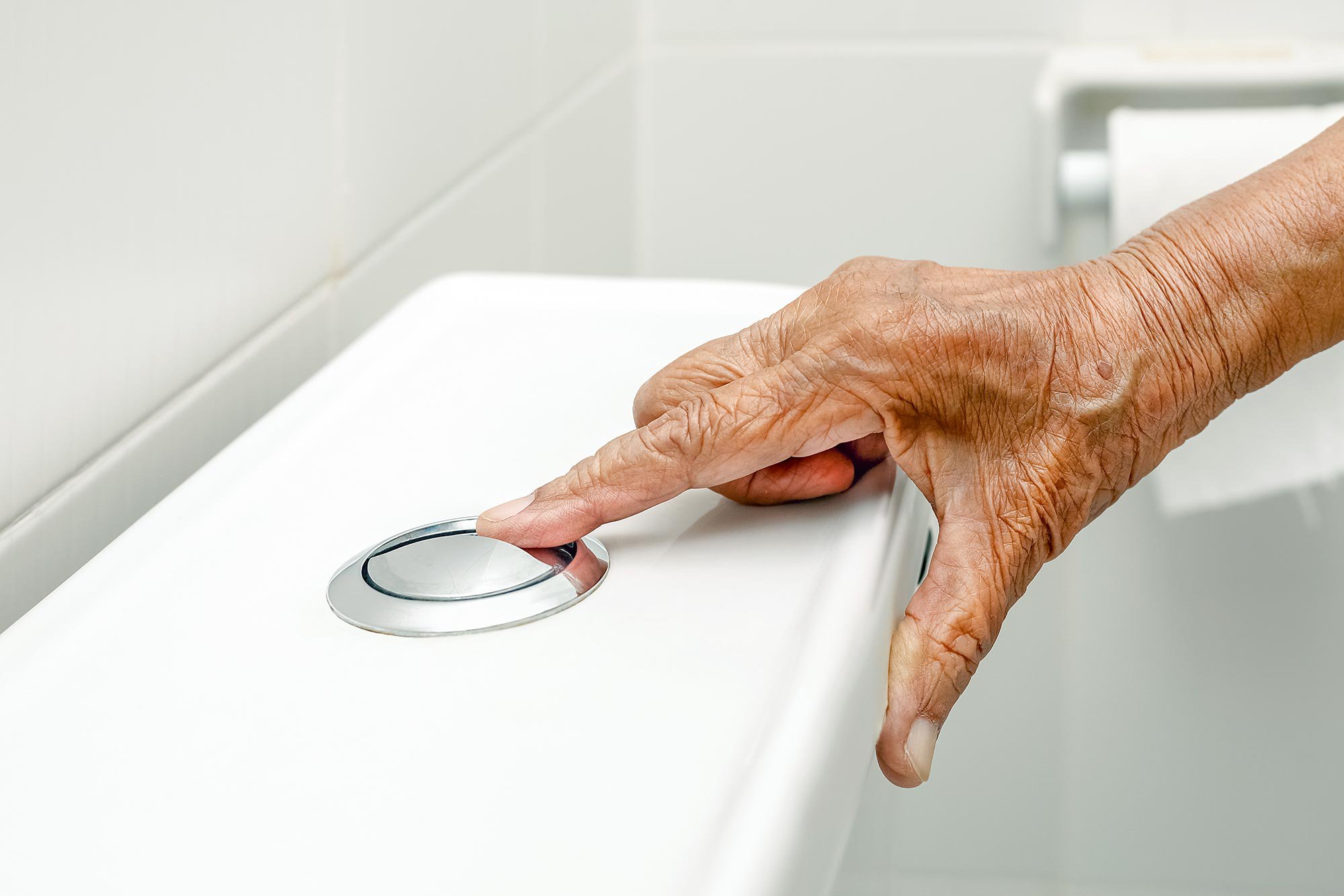 Elderly-Woman-Flushing-Toilet.jpg