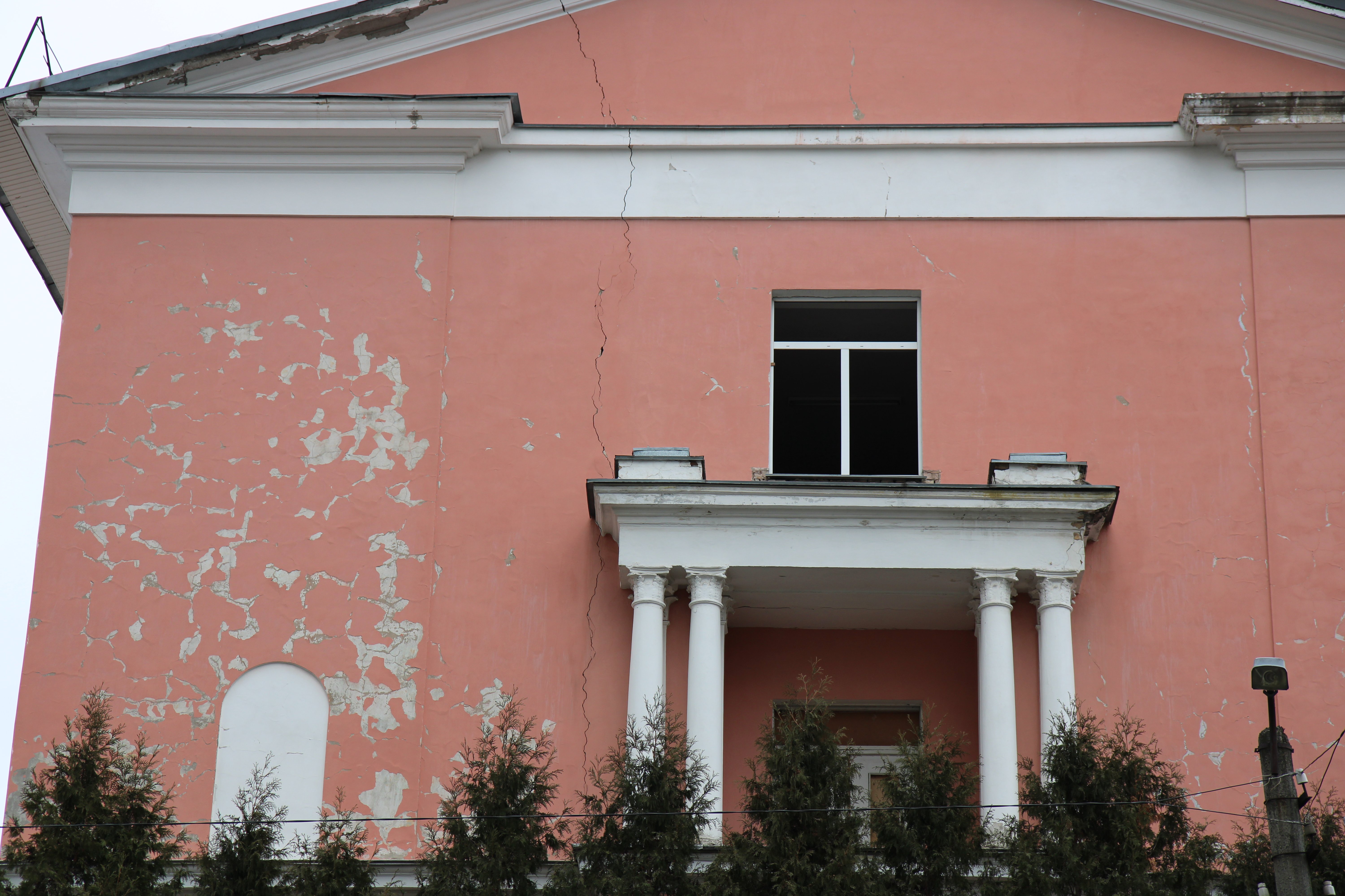 Broken glass and a crack on the college facade