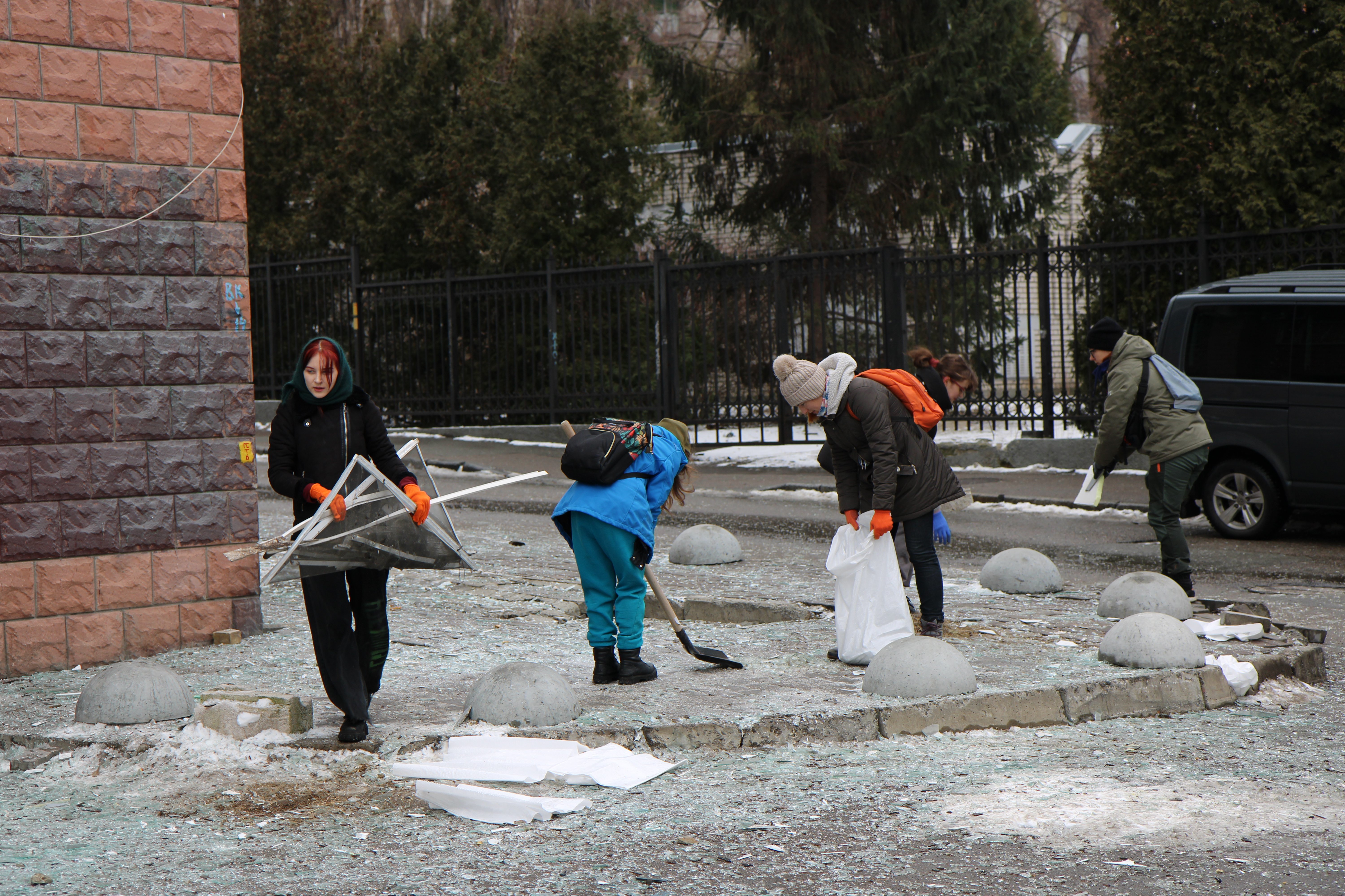 Volunteers help clean up glass shards