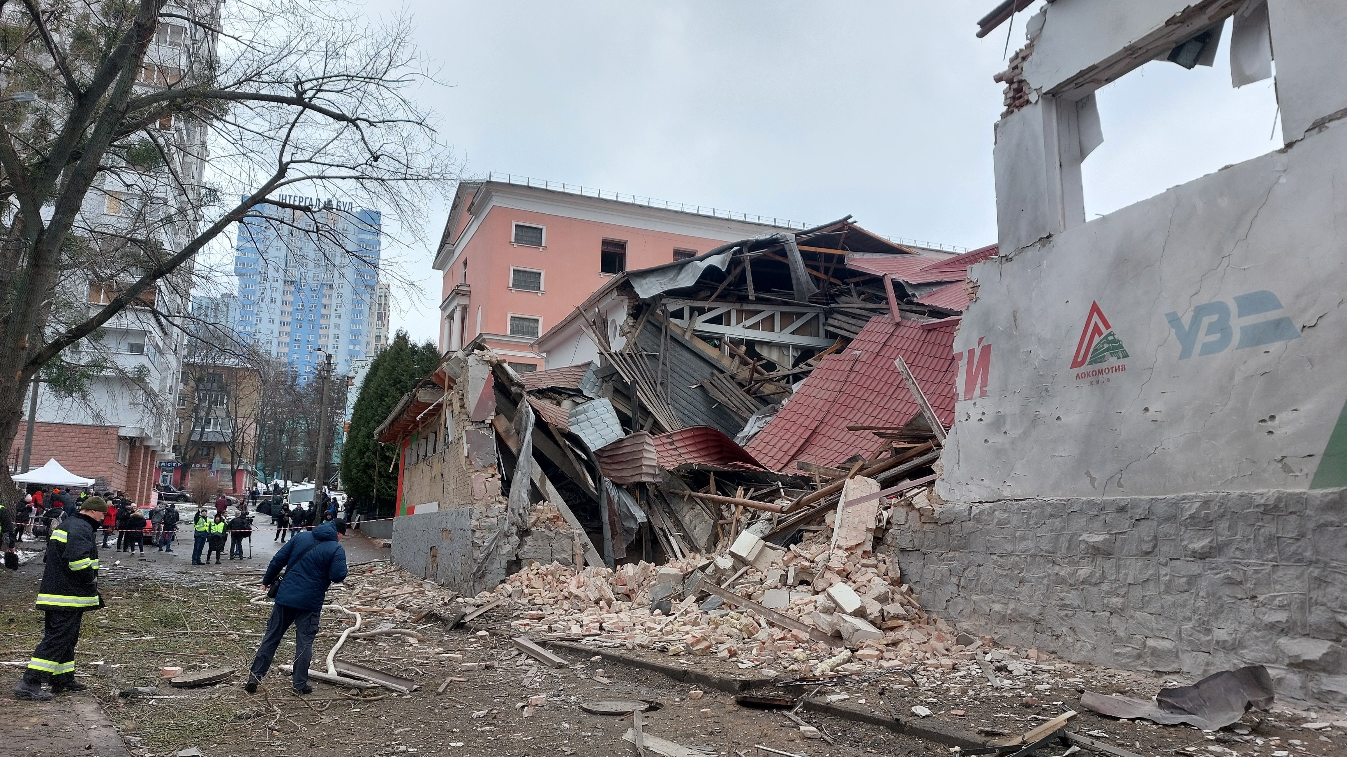 Emergency workers clear the rubble of a sports complex